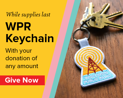 A set of keys on a wooden surface includes a Wisconsin Public Radio keychain. Text promotes receiving the keychain with any donation.